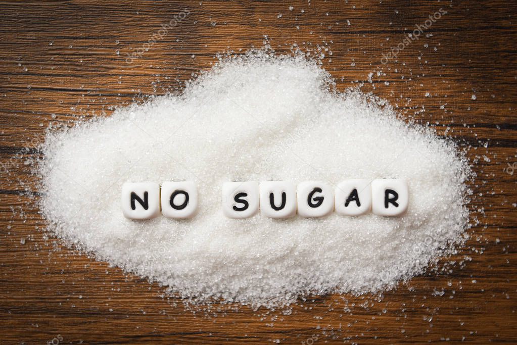 no sugar text blocks with white sugar on wooden background - sug