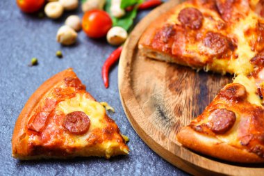 Ahşap Tepsi ve domates biberli fesleğen yaprak üzerinde pizza dilim d