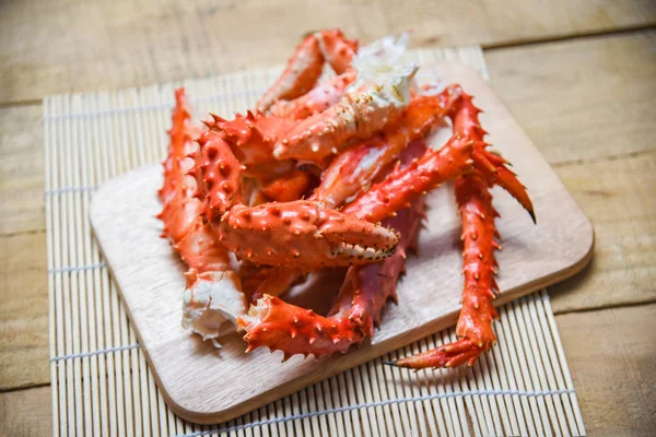 Alaskan King Crab Legs cooked seafood on wooden cutting board ba