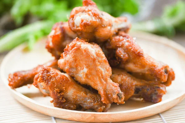 Fried chicken wings on wooden plate - Baked chicken wings BBQ