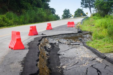 Asfalt yol çöktü ve yol kenarında çatlaklar oluştu.