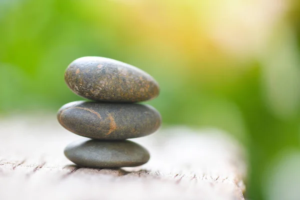 Natural wellness concept - Relax zen stones stack on wooden natu