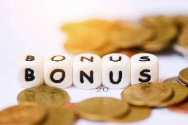 Yıllık Bonus konsepti / Bonus ve Stack madeni paralarının takvim arkaplanındaki sözleri masa başı şirketinin moralini yükseltmek için.