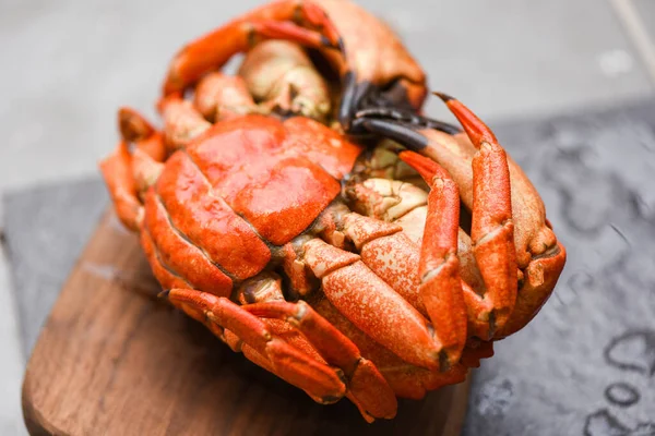 Fresh crab on wooden board for making cooked food / Seafood shellfish Steamed red crab or Boiled stone crab