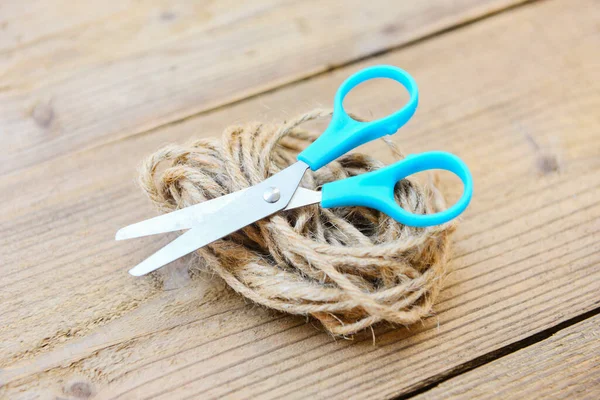Rope and scissors on wooden background / Hemp rope or Natural rope