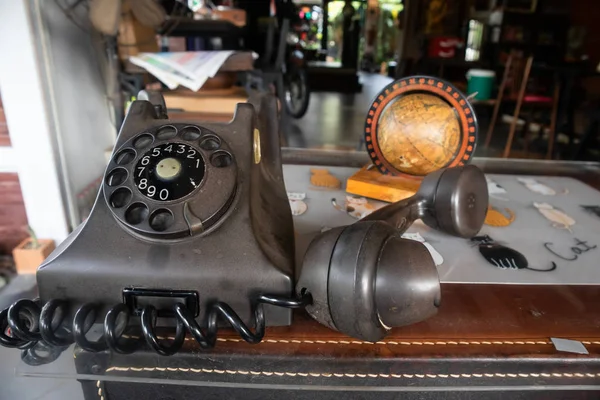 Antique phone with newspaper On the table