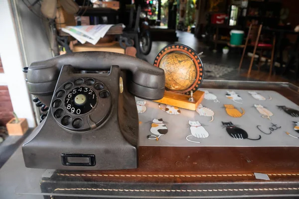 Antique phone with newspaper On the table