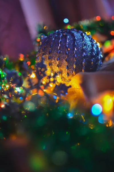 Palla blu e decorazioni natalizie nelle luci di una ghirlanda — Foto Stock
