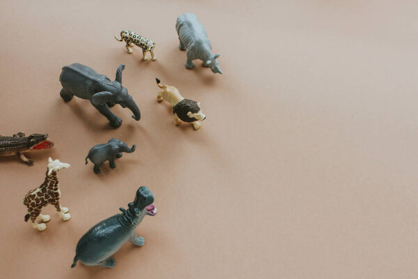 plastic toy figures of animals. concept of nature protection. space for text, top view