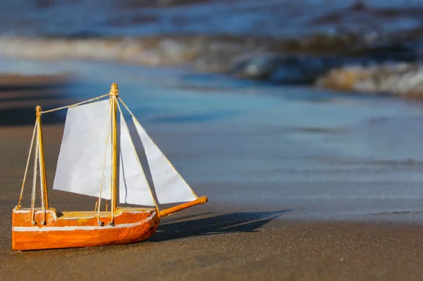 model of a sailing ship made of wood, paper on the shore. children's toys, Hobbies.