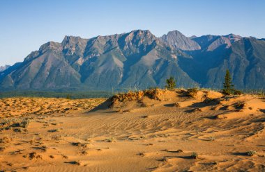 Chara sands and Mountains Kodar ridge in Eastern Siberia  clipart