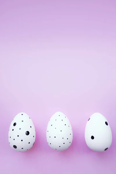 Three Easter eggs on pink background. Easter concept. Copy space