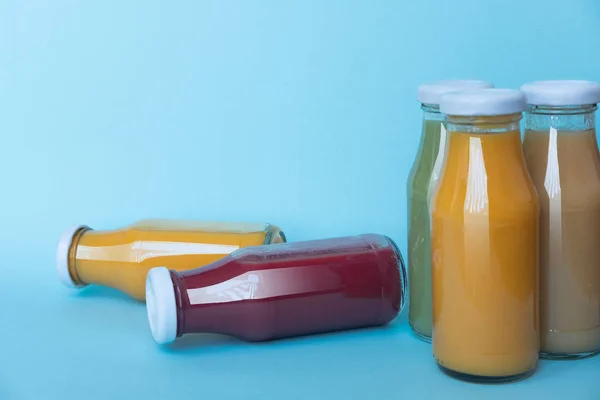 Fresh and healthy juice in a bottle isolated on a blue background