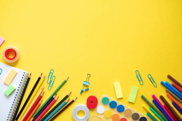 School supplies on yellow background. Concept back to school. Copy space
