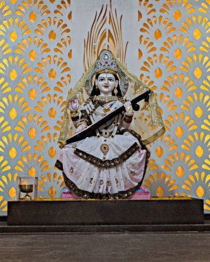 Nicely decorated Idol of Hindu Goddess Saraswati in a temple at Yavatmal, Maharashtra, India. clipart