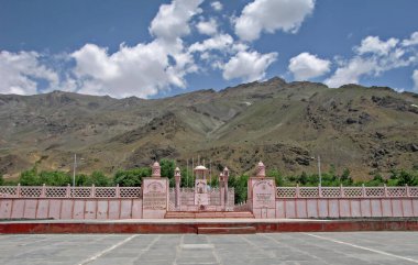 Kargil, Jammu and Kashmir-June 27th, 2011: Memorial built for remembrance of India's win in Kargil War, called as Operation Vijay memorial on the background of Tololing hills and nice sky. clipart