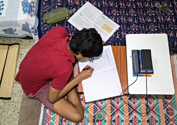 Pune, India - June 2nd, 2020 : Student pursuing online education through cell phone due to closed schools on account of spread of pandemic COVID-19, corona virus in Pune, Maharashtra, India.