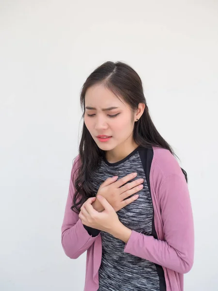 Women press the chest with pain. She is suffering from chest pain. Have a heart attack