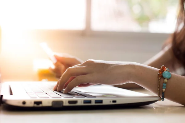 Woman hand is holding a calculator. Computer Key to Calculate Spending Planning