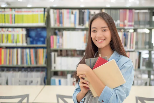 Beautiful women are reading and researching in the university library.