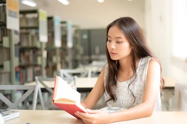 Beautiful women are reading and researching in the university library.