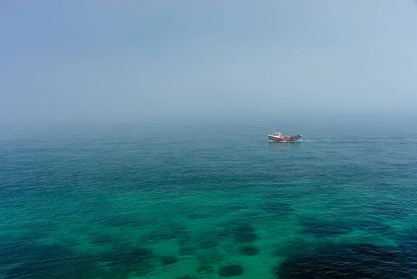 Fiskaren båt på dimmiga havet — Stockfoto