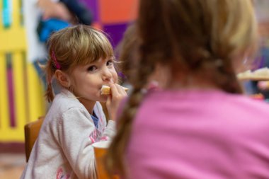 Doğum günü partisinde sandviç yeme kız