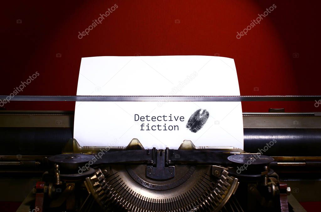 Typewriter spelling detective fiction on paper with finger print