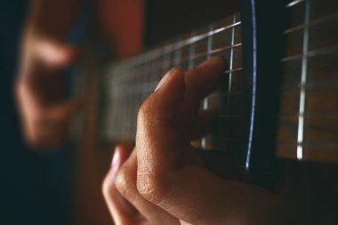 Close up of an acoustic guitar being played clipart