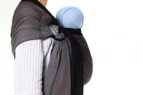 A newborn baby in blue hat in a ringsling baby carrier in vertical position — Stock Photo, Image