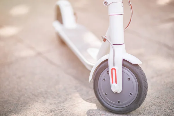 White electric scooter on the grey road — Stock Photo, Image