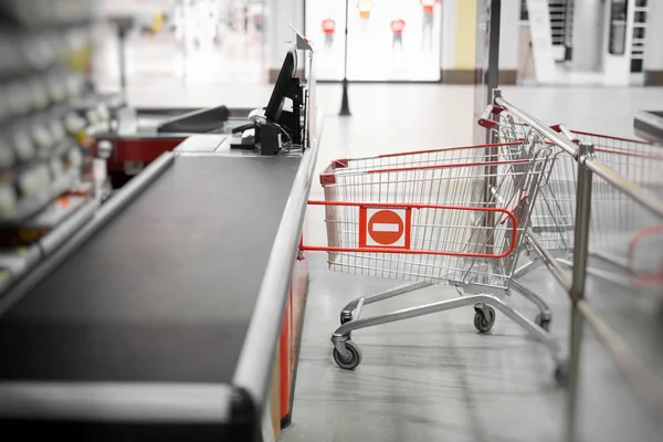 Empty cash desk with closed way border in supermarket