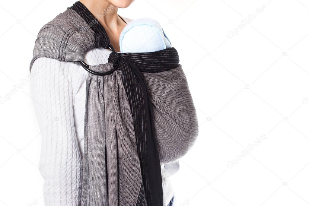 Newborn baby wraped in a ring sling baby carrier side view