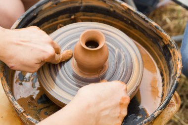 Çocuklarla çömlekçi tekerleğinde seramik üretim sürecine yakından bak. Çocuk konsepti ile Kil el sanatları.