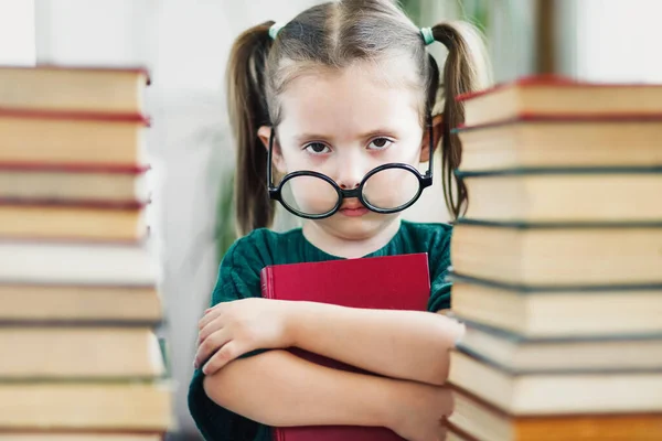 本の中で彼女の鼻の上に大きな丸いメガネを持つ少女を読んで疲れの肖像画 子供教育の概念 読書から目の疲労 選択的ソフトフォーカス — ストック写真
