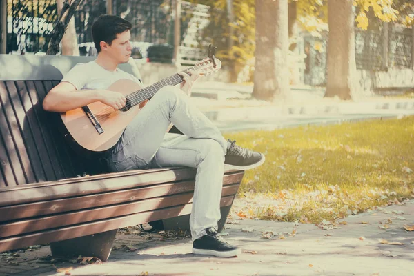 Young Man Sitting Bench Park Playing Acoustic Guitar Capo Young — Stock Photo, Image