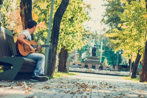Young Man Sitting Bench Park Playing Acoustic Guitar Capo Young — Stock Photo, Image