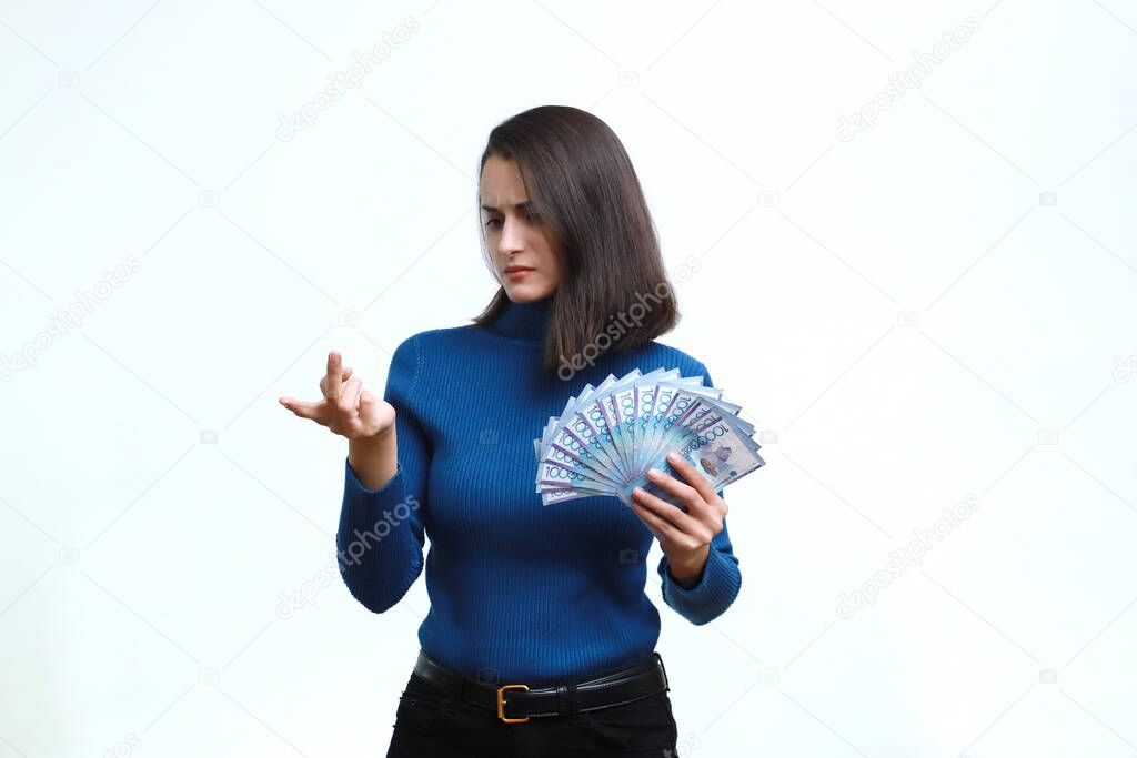 Girl counts Kazakhstan money on a white background.