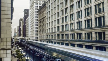 Dramatic Shot of Downtown Chicago's Above Ground Metro Streaks Through Buildings clipart