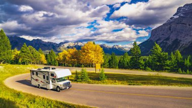 Autumn RV Motorhome Camper On Scenic Highway clipart