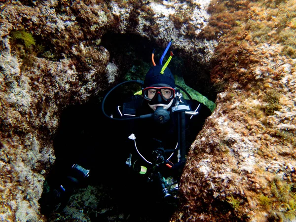 Dry suit diver. Cavern diving. Mediterranean, Malta.