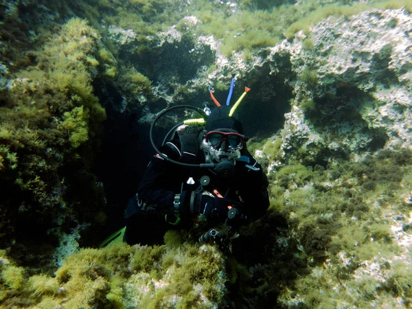 Dry suit diver. Cavern dive. Mediterranean, Malta.