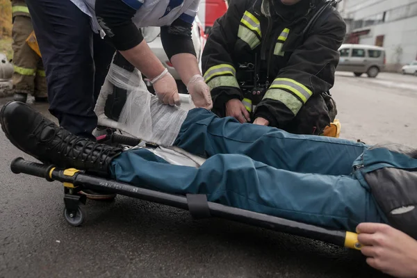 law enforcement team use light stretcher for medical evacuation to vehicle in training course