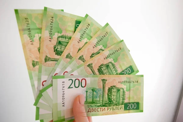 Russian money in the hand on a gray background.