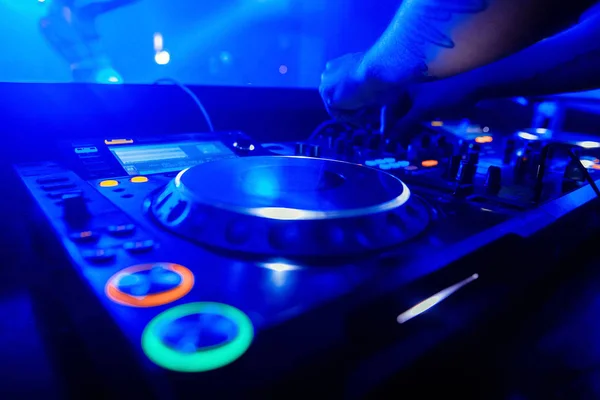Dj playing the track in the nightclub at party closeup