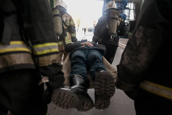 law enforcement team use light stretcher for medical evacuation to vehicle in training course