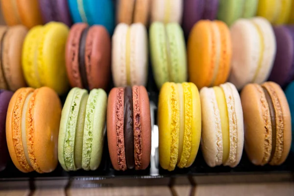 Colorful french macarons background, close up.Different colorful macaroons background.Tasty sweet color macaron,Bakery concept.Selective focus.
