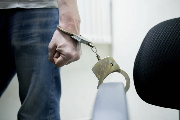 Closeup view of handcuffed man rising his hands.