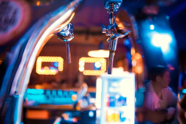 Shiny beer taps in a row in a bar