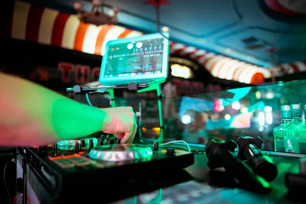 DJ mixing music on console at the night club